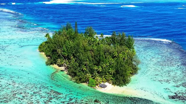Aerial drone flyby of tropical island and turquoise lagoon in tahiti, French Polynesia
