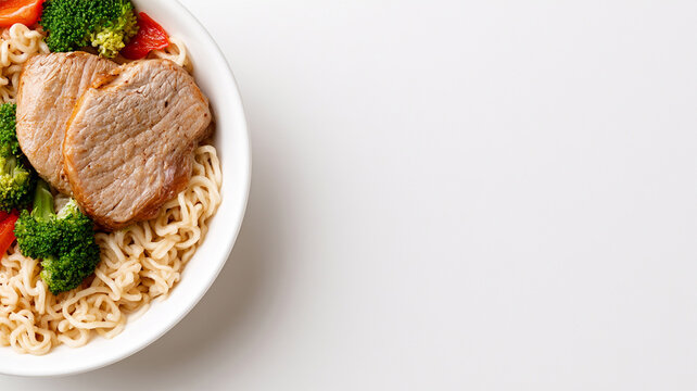 Grilled pork with instant noodles and fresh broccoli in white bowl, top view with copy space