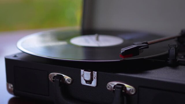 Close up of black vinyl record spinning on vintage turntable record player