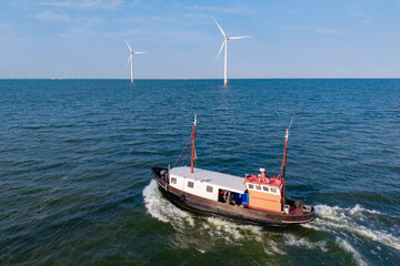 Fototapeta premium Exploring windmill park in flevoland's blue waters