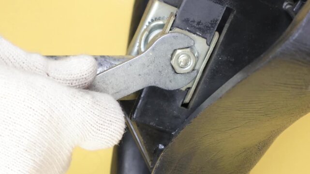 Tighten the bolt on the tube clamp under the bicycle seat post. Cyclist repair concept