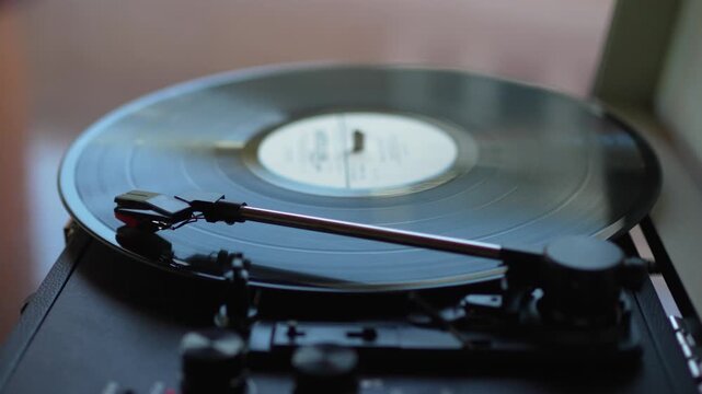 Close up of black vinyl record spinning on vintage turntable record player