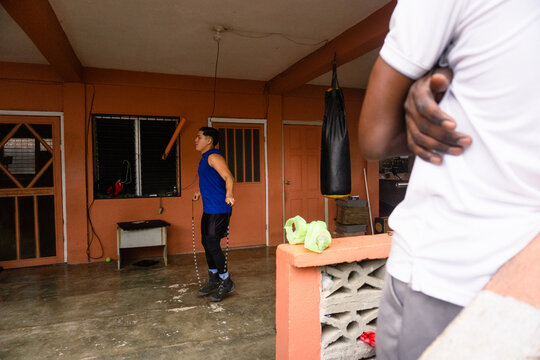 Young athlete skipping rope training boxing skills
