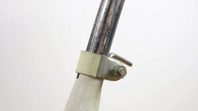 Tightens screw with 13mm wrench, clamp holds tube to bicycle saddle.