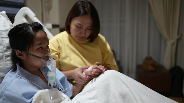 A concerned mother holds her sick child's hand while the child receives oxygen therapy in a hospital bed. Family support, pediatric healthcare, compassion, medical treatment, and hope for recovery.