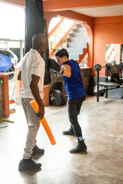 Young athlete training boxing with coach guidance