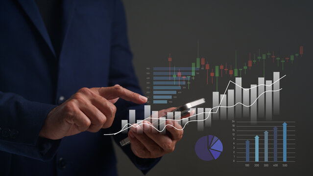 A person in business attire uses a smartphone with overlaid financial charts and graphs indicating data analysis and growth trends.