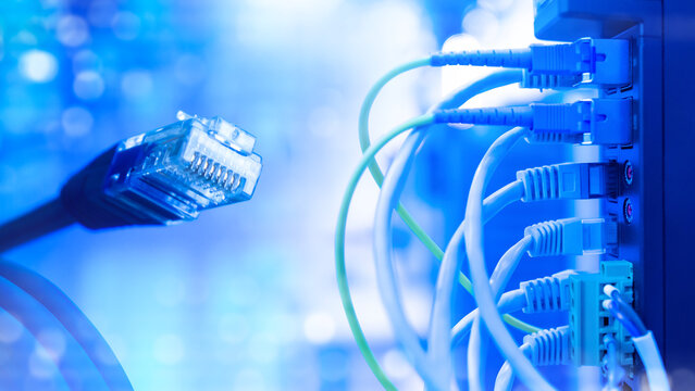Data center. Ethernet cable connects to a network switch, supporting high speed data transmission, server infrastructure, cloud computing and enterprise networking.