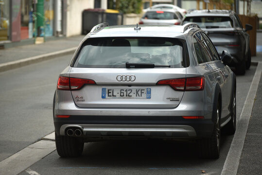 St - Amand Montrond - France - 3 august 2026 - Rear view of a grey Audi A4 Avant quattro station wagon parked on a street, showing a premium vehicle in an urban environment.
