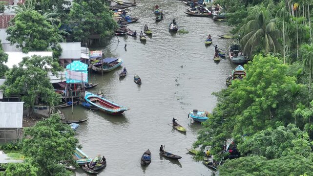 People paddling boats at the banaripara floating guava market in bangladesh