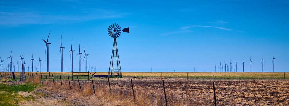 Old windmill in a field of modern wind turbines west of Amarillo Texas.