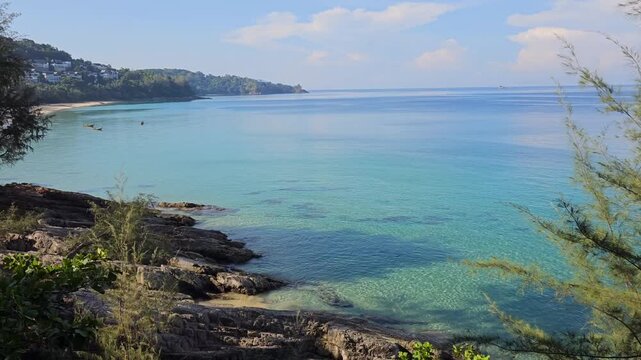 Turquoise Andaman sea, calm water and beautiful coast at sunny day. Nai Thon Beach, Phuket, Thailand
