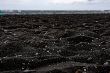 Low angle view of a black sand beach with volcanic pebbles on the Big Island Hawaii © Joao Vieira