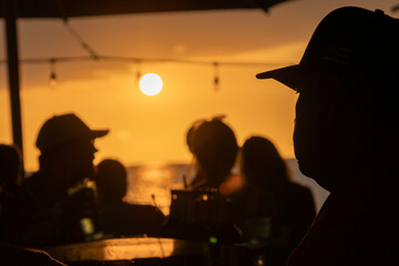 Close silhouette of a person in a hat at sunset over the ocean on the Big Island Hawaii © Joao Vieira