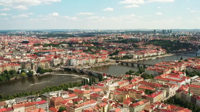 Aerial view of Prague cityscape with bridges crossing Vltava river. Historic landmark location showcases city bridges and urban skyline. Scenic panorama represents european travel destination.