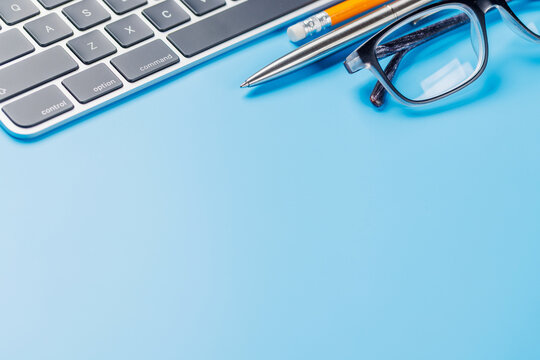 Office supplies on blue desk