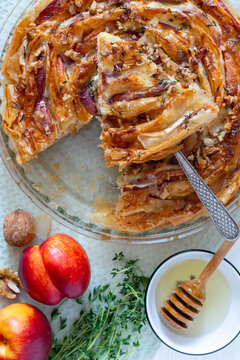 Golden spiral pie with peach and cheese layers.