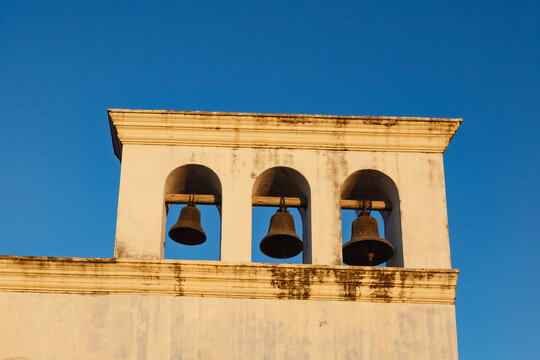 3 bells in cathedral bell tower against the blue sky