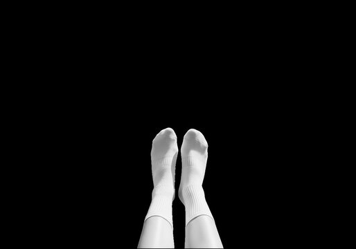 Feet in light blue socks lying on bed isolated on transparent background