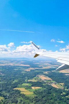 London, United Kingdom, July 10, 2026: Aerial View from Ryanair Plane Wing Over Serene Landscape on a Sunny Day