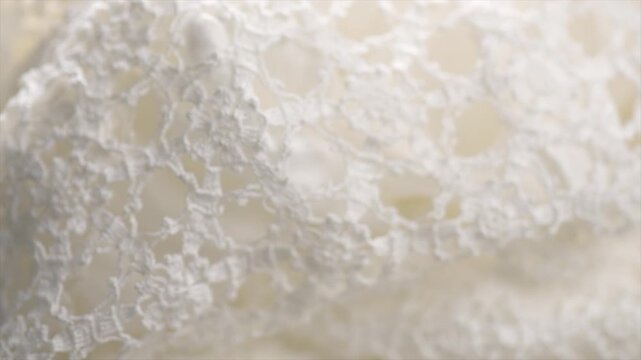 Crochet lace patterns, crocheted Grandmas Doily, Detail of hand-crocheted tablecloth background art design. Wedding tablecloth, Craft, vintage. Hobby concept. Rotating background. 