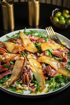 Salad with Pear, Arugula, Jamon, Blue Cheese and Blueberry, Delicious Fresh Salad Appetizer on Bright Background