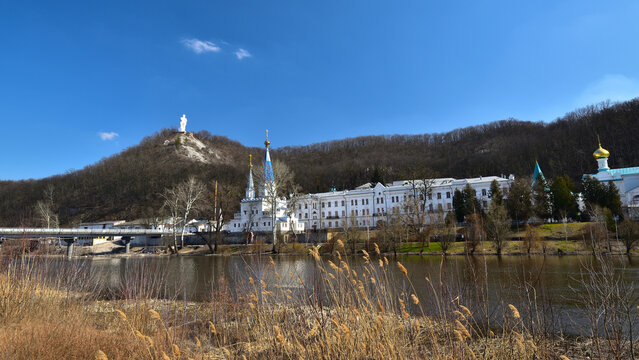 View of the Svyatogorsk Lavra and the monument to Artem on a sunny spring day.