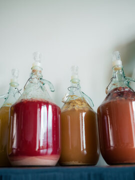Bottles of Colorful Drinks on a Shelf in a Kitchen