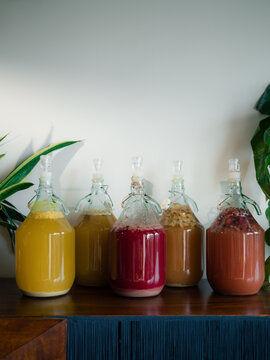 Bottle row with different fermenting drinks 