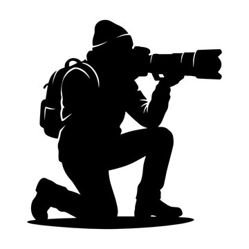 Silhouette of a professional wildlife photographer kneeling with a telephoto lens camera and backpack