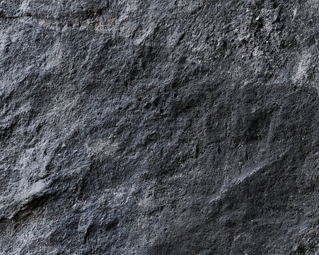 Dark basalt and slate stone texture with a riven matte finish and deep shadows for premium food backgrounds and product mockups
