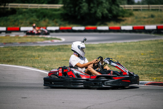 Teenage boy speeding through a corner in a go-kart outdoor race