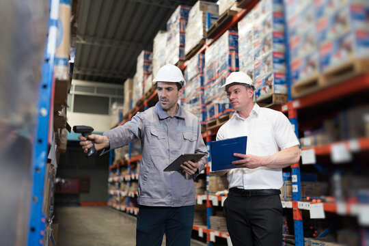 Team of warehouse worker manage inventory, process incoming and outgoing stock, organizes and fulfill orders inside a storage or distribution facility