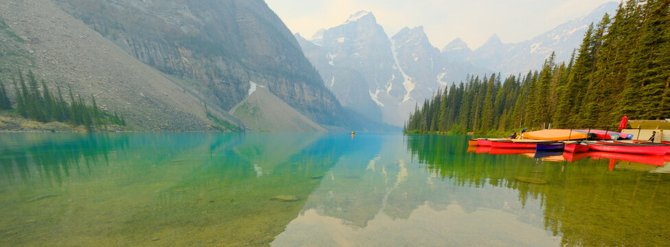 Red Canoes Docked at Moraine Lake in Banff National Forest in Alberta Canada