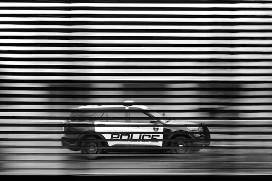 Black and White Police Car Vehicle Through Window Blinds Seeing Out