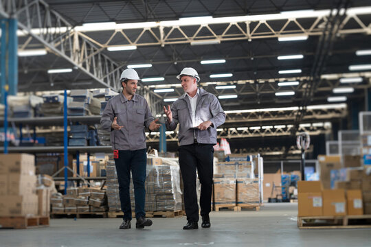 Team of warehouse worker manage inventory, process incoming and outgoing stock, organizes and fulfill orders inside a storage or distribution facility