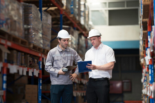 Team of warehouse worker manage inventory, process incoming and outgoing stock, organizes and fulfill orders inside a storage or distribution facility