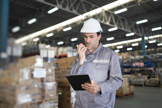 Male warehouse worker manage inventory, process incoming and outgoing stock, and fulfill orders inside a storage or distribution facility