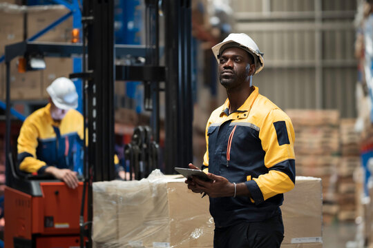 Warehouse, deposit or storage concept. Warehouse worker at work, organizes, and moves stock inside a storage or fulfillment center