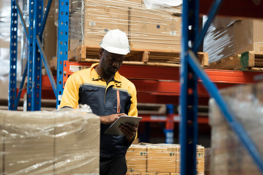 Warehouse, deposit or storage concept. Warehouse worker at work, organizes, and moves stock inside a storage or fulfillment center