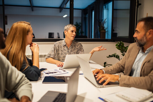 Team meeting with manager leading discussion in modern office
