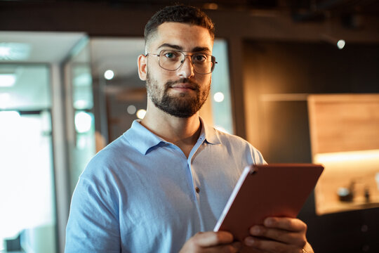 Confident professional man using tablet in modern office