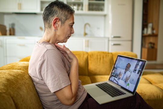 Older woman consulting doctor via video call at home