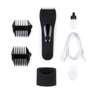 Flat lay product photography of a electric trimmer kit with attachments, charging dock, USB cable, oil bottle, and brush, neatly arranged on a solid light grey background.