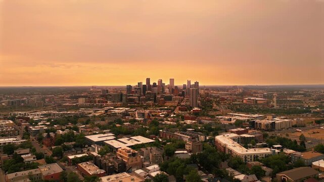 Orange sunrise over Denver Skyline on August 3rd 2026 with wildfire smoke 