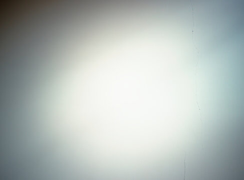 Sun rays on the cracked wall texture background