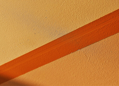Diagonal orange line on the wall backdrop