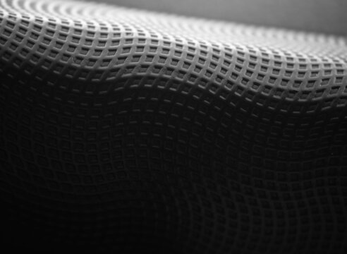 Black and white perforated grainy tilted texture backdrop