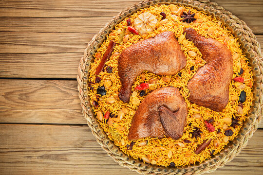 Arabic Cuisine; "Chicken Kabsa" is the national Saudi Arabian dish. It's consisting of basmati rice and roasted chicken. Decorated with nuts, raisins, herbs and spices.