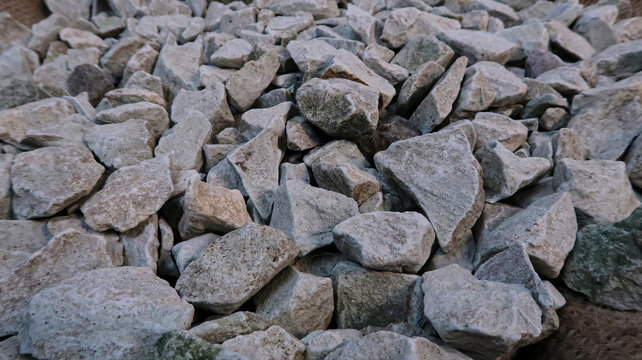 Close up texture of crushed limestone gravel stones pile for construction aggregate material background. 